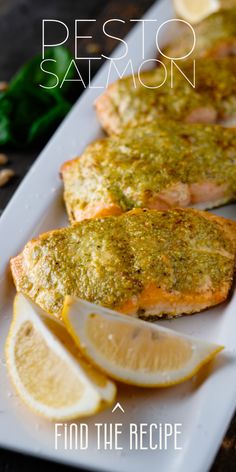 grilled salmon with pesto and lemon on a white plate