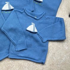 Original Baloo Baleerie design Sailboat sweaters make a great gift for the little ones in your life! Blue sweater with a Sailboat motif is 100% cotton. Hande-loomed in Maine. Machine washable.  Features: *Rolled hem pull over  *made from 100% American cotton *Hand Loomed in Maine *Colorfast and easy care *Machine wash & dry * Sweaters are pre-washed to minimize shrinking Custom orders in the following sizes 3-6 months 6-9 months 9-12 months 12-18 months 2T 4T *please contact us for additional sizes Blue Cotton Knit Sweater, Playful Cotton Sweater With Ribbed Cuffs, Playful Knitted Crew Neck Top, Cute Blue Sweater For Playtime, Nautical Cotton Tops For Fall, Playful Cotton Crew Neck Sweater, Playful Blue Knitted Sweater, Blue Crew Neck Sweatshirt For Playtime, Blue Long Sleeve Sweater For Playtime