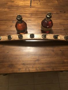 two bottles sitting on top of a wooden table