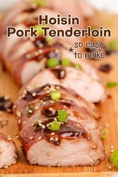 pork tenderloin on a cutting board with sesame seeds and garnishes