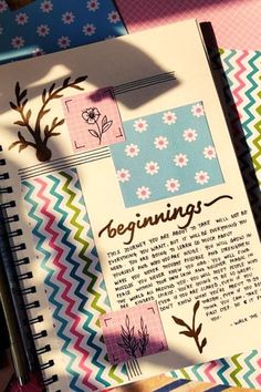 an open book with paper flowers and writing on the pages that read,'beginnings '