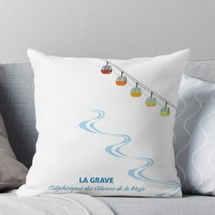 a throw pillow with the words la grave hanging from a wire above it, on a couch