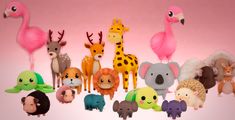 a group of stuffed animals and giraffes on a pink background with the same animal