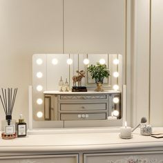 a vanity with lights on it and a mirror in the backround behind it