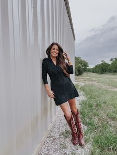 Our Black Hills Dress pairs stretchy faux suede material with playful fringe & the result is as ready for those post-rodeo celebrations as you are. Features a wrap belt with tie. 92% Polyester 8% Spandex Pressley is 5’4”, a size 25 & extra small top wearing a 2 Cowgirl Cocktail Dress, Black Dress With Cowgirl Boots, Western Wedding Dresses Guest, Long Dress With Cowboy Boots, Dresses To Wear With Cowboy Boots, Dress With Cowgirl Boots, Vogue Home, Dresses With Cowboy Boots, Western Dress