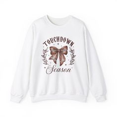 The Touch Down Sweatshirt offers a cozy and comfortable wearing experience with its classic fit and crew neckline. Perfect for colder months, this sweatshirt is made with a medium-heavy fabric blend of 50% cotton and 50% polyester. The double-needle stitching ensures durability, while the seamless design reduces fabric waste. Ideal for those who appreciate quality and comfort, this sweatshirt is perfect for casual wear or lounging at home. Suitable for football enthusiasts and fans of fall and winter seasons. Product features - Medium-heavy fabric blend of 50% cotton and 50% polyester - Classic fit with crew neckline for a comfy wearing experience - Seamless design reduces fabric waste - Durable double-needle stitching at key seams - Suitable for football enthusiasts and fall/winter season White Fleece T-shirt For Winter, Fall Slogan Hoodie With Crew Neck, Fall Slogan Crew Neck Hoodie, Winter Graphic Print Crew Neck Sweats, White Graphic Print Sweats For Winter, Winter Letter Print Sweats With Crew Neck, Winter Slogan Crew Neck Sweatshirt, Winter Crew Neck Sweats With Letter Print, Winter Letter Print Crew Neck Sweats