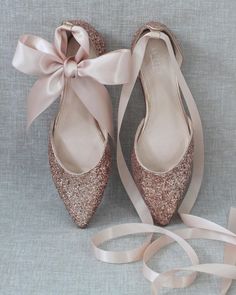 a pair of shoes with a ribbon tied around them