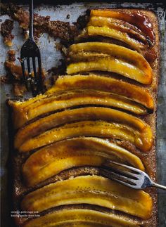 sliced bananas on a baking sheet with a fork