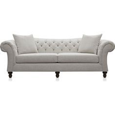 a white couch with two pillows on it