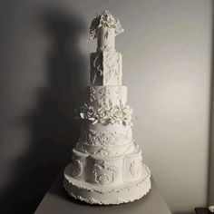 a large white wedding cake sitting on top of a table