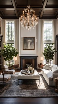 a living room filled with lots of furniture and a chandelier above the fireplace