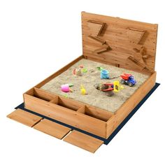 an open wooden sandbox with toys in it