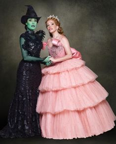 two women dressed in costumes pose for a photo