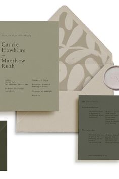 the wedding stationery is laid out on top of each other, including an envelope with a monogram