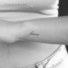 a woman's arm with the word love tattooed on it