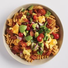 a white bowl filled with pasta and vegetables