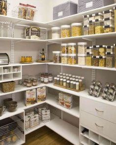 an organized pantry with white shelving and lots of food