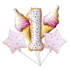 an ice cream cone and star shaped balloons are arranged in the shape of number one