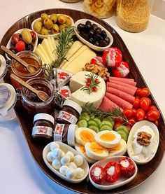 a platter filled with lots of different types of cheeses and meats on it