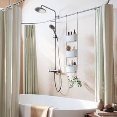 a bath tub sitting next to a shower with a shelf on the wall above it