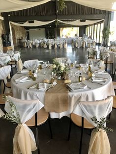 the tables are set up with white linens