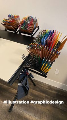 a bunch of colored pencils sitting on top of a table next to each other