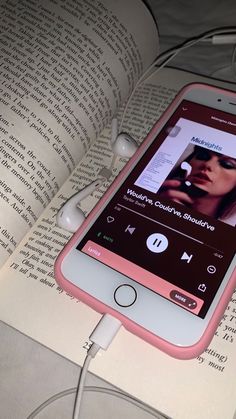 an mp3 player is plugged into the earbuds of a book with headphones