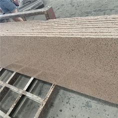 a man standing next to a pile of cement