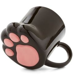 a black and pink cat paw shaped coffee mug