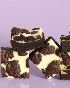 chocolate brownies with white frosting on purple background