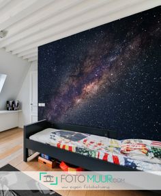 a bed room with a neatly made bed and a large wall mural on the wall