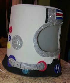 a white hat with silver sequins and an eyeball on it's side