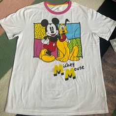 a mickey mouse shirt is laying on the floor