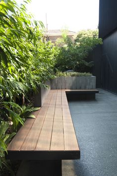 a wooden bench sitting in the middle of a garden