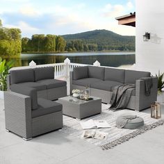 an outdoor living room with grey furniture