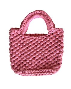 a pink handbag is shown on a white background with the handle extended and it's woven material