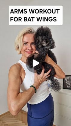 a woman holding a black poodle in her arms with the caption arms workout for bat wings