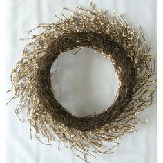 a wreath made out of twigs on a white sheet