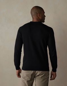 A versatile classic that's here to stay. Back by popular demand in a long sleeve version, this polo offers breathable comfort and superior softness with its Robles Yarn's 14gg Fine Knit composition. Crafted from 100% cotton soft sweater knit, it's your ultimate go-to for effortless style and comfort. Black Polo Collar Sweater For Work, Black Cotton Polo Sweater For Work, Black Fitted Cotton Polo Sweater, Fitted Black Cotton Polo Sweater, Black Polo Collar Sweater For Winter, Black Crew Neck Polo Sweater With Ribbed Cuffs, Black Polo Sweater With Ribbed Cuffs, Classic Polo Sweater With Ribbed Collar For Layering, Classic Black Polo Sweater With Ribbed Collar