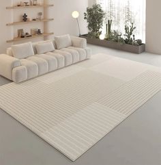 a large white couch sitting on top of a rug