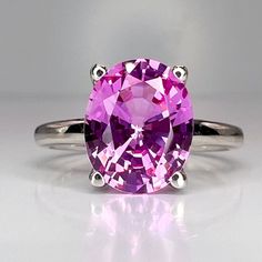 "The ring pictured is a lab created pink sapphire #6448 This ring can be made with many different stone colors Message us for pricing on different color/type stones -Approximate total carat weight:  approx. 3.00ctw diamond equivalent  -Center Stone Size:  10x8mm - approx. 3.00ct diamond equivalent -Center Stone Shape: oval -Gem Type:  lab created  sapphire  -Stone Clarity: VS2 -Stone Color: Medium Pink -Moh's Scale: 9 hardness -Metal Type and Purity: 14k white gold -Setting: 4 prong open U head Pink Rings, Sapphire Anniversary Ring, Sapphire Anniversary, Sapphire Solitaire Ring, Sapphire Solitaire, White Gold Set, Ring Birthstone, Sapphire Engagement Ring, Ring Pictures