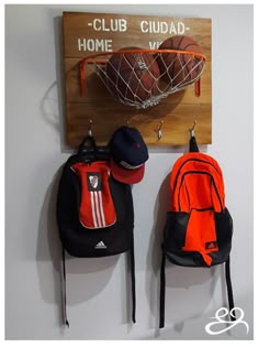 two backpacks are hanging on the wall next to a sign that says club cuad - home