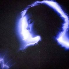 a woman's profile is shown in blue light