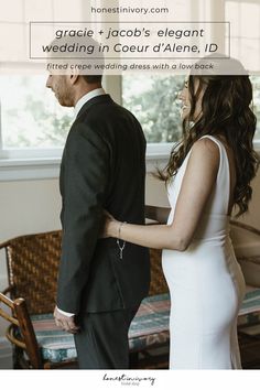 a man in a suit and tie standing next to a woman in a white dress