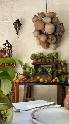 a woman sitting at a table with fruit on it