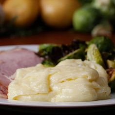 a white plate topped with ham and broccoli