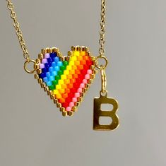 Are you looking for the perfect LGBTQ rainbow heart necklace for someone special this Valentine's season? Or a unique pride necklace to spoil yourself? Made with tiny Miyuki beads and tarnish-free stainless steel chain and letters, my custom initial necklace is the perfect LGBTQ Valentine's gift idea! My unique Miuyki bead necklace is a great gift idea for any special occasion to all the women in your life. You can't go wrong when gifting my custom rainbow heart necklace! DETAILS - PLEASE READ C Heart Pendant Jewelry With Colorful Beads For Gift, Heart-shaped Colorful Beads Jewelry For Gifts, Valentine's Day Multicolor Beaded Necklaces, Valentine's Day Heart Shaped Multicolor Beaded Necklaces, Valentine's Day Necklaces With Colorful Beads, Valentine's Day Multicolor Heart Beaded Necklace, Heart Charm Beaded Necklace For Gift, Heart Charm Beaded Pendant Necklace For Gift, Multicolor Beaded Necklaces With Heart Charm As Gift