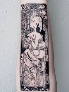 a black and white tattoo on the arm of a woman with an image of a cat