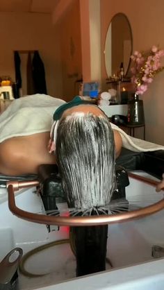 a woman laying on top of a hair dryer