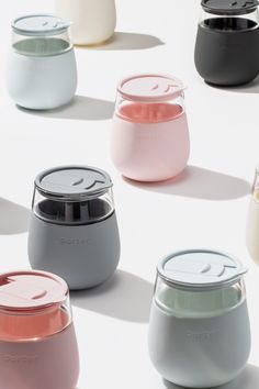 many different colored jars with lids on them